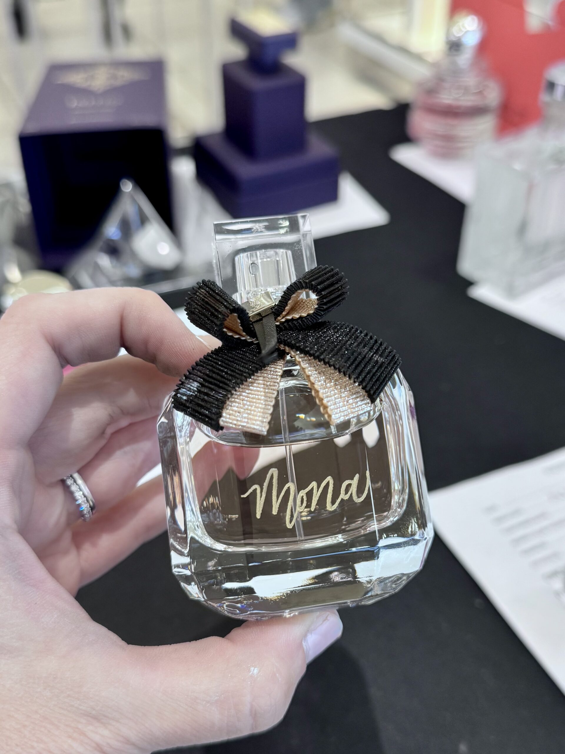 Glass-Bottle-Black-Gold-Ribbon-YSL-Yves-Saint-Laurent-Mon-Paris-Lumiere-Eau-de-Toilette-Calligraphy-Engraved-Mona-Live-Event-Artist-KPCalligraphy-Nordstrom-Atlanta-Georgia-2025-scaled.jpg